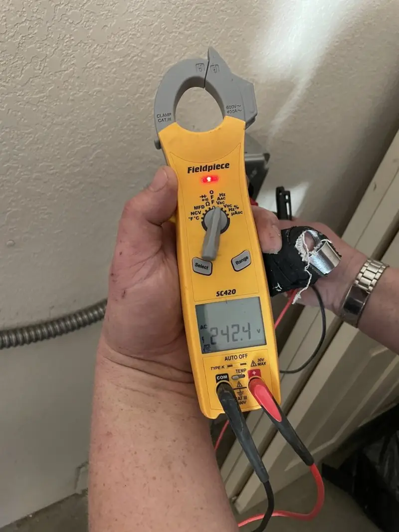 Voltage testing with clamp meter during Outlet Installation in Tipton